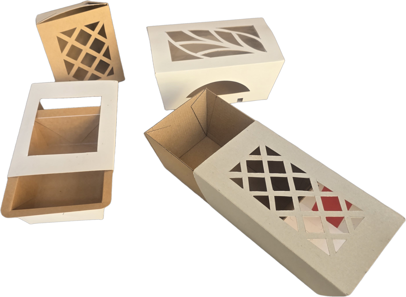 A group of die-cut kraft and white window boxes — varied formats showing the same material treatment
